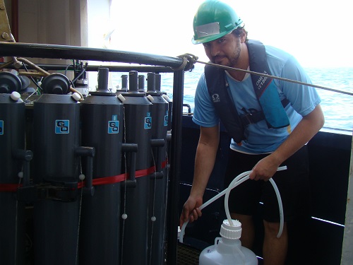 Study co-author Moustapha Harb collects water from the rosette sampler used to assess coastal water quality.