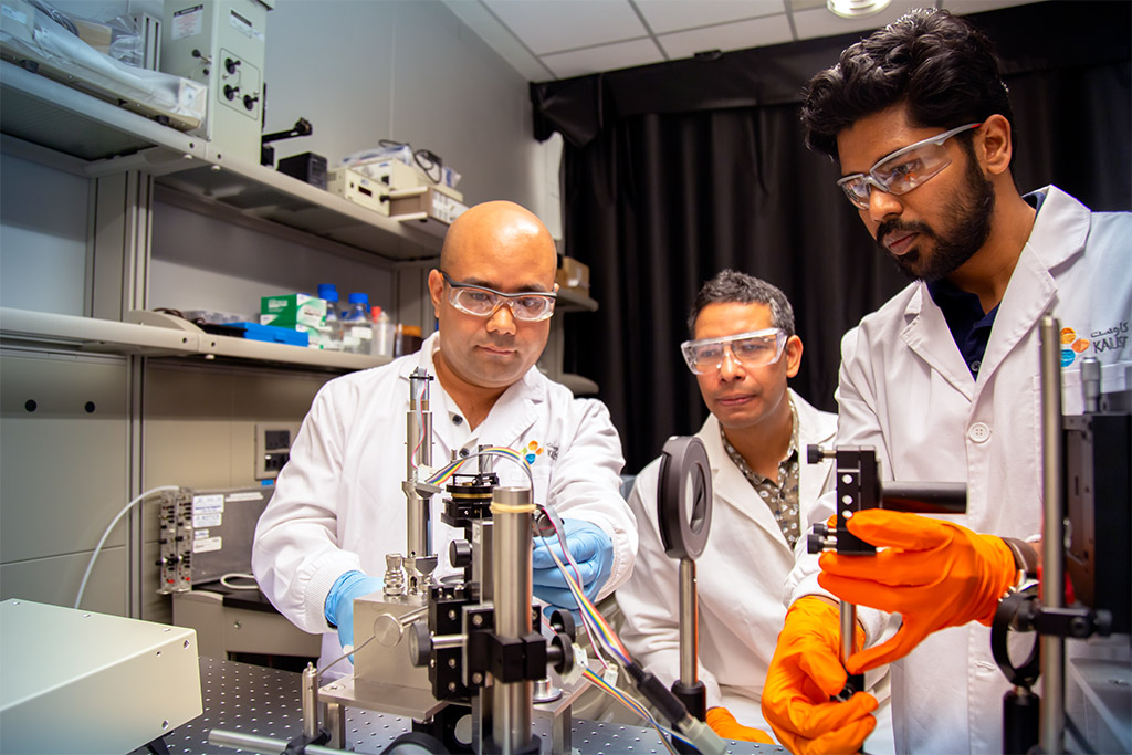 Buddha Shreshtha (left) and Sreekiran Pillai (right) fine tune the optics of the surface force apparatus as Himanshu Mishra observes.