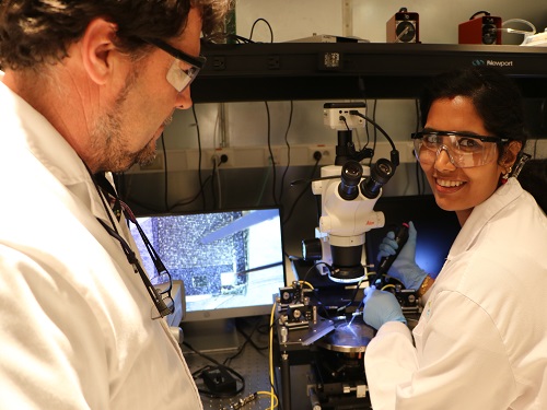 Shilpa Sivashankar and Ulrich Buttner depositing CRP on their biosensor chip and testing it under the microscope using an electrical probe station.