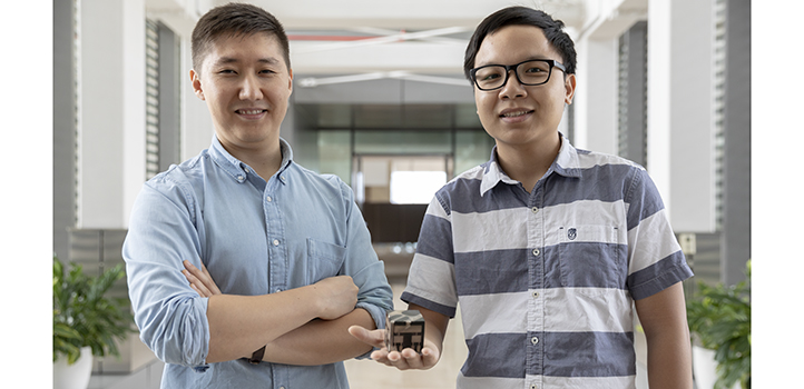 Students Azamat Bakytbekov (left) and Thang Nguyen helped to develop a cube-shaped energy harvester that can gather power from a nearby smartphone.