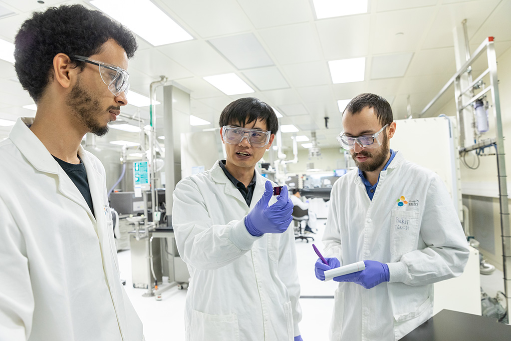 (l-r) Co-authors Abdullah Alsalloum, Xiaopeng Zheng and Bekir Turedi discuss the process for making inverted perovskite solar cells without the use of unstable dopants.